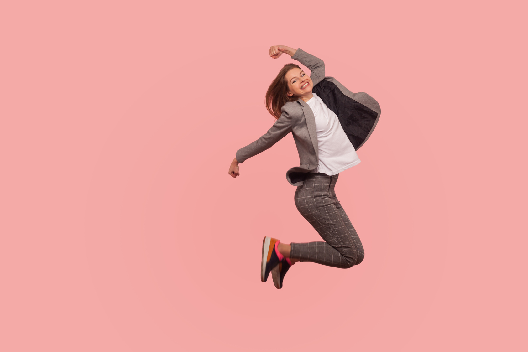 Emotional Young Woman in Jacket on Pink Background.