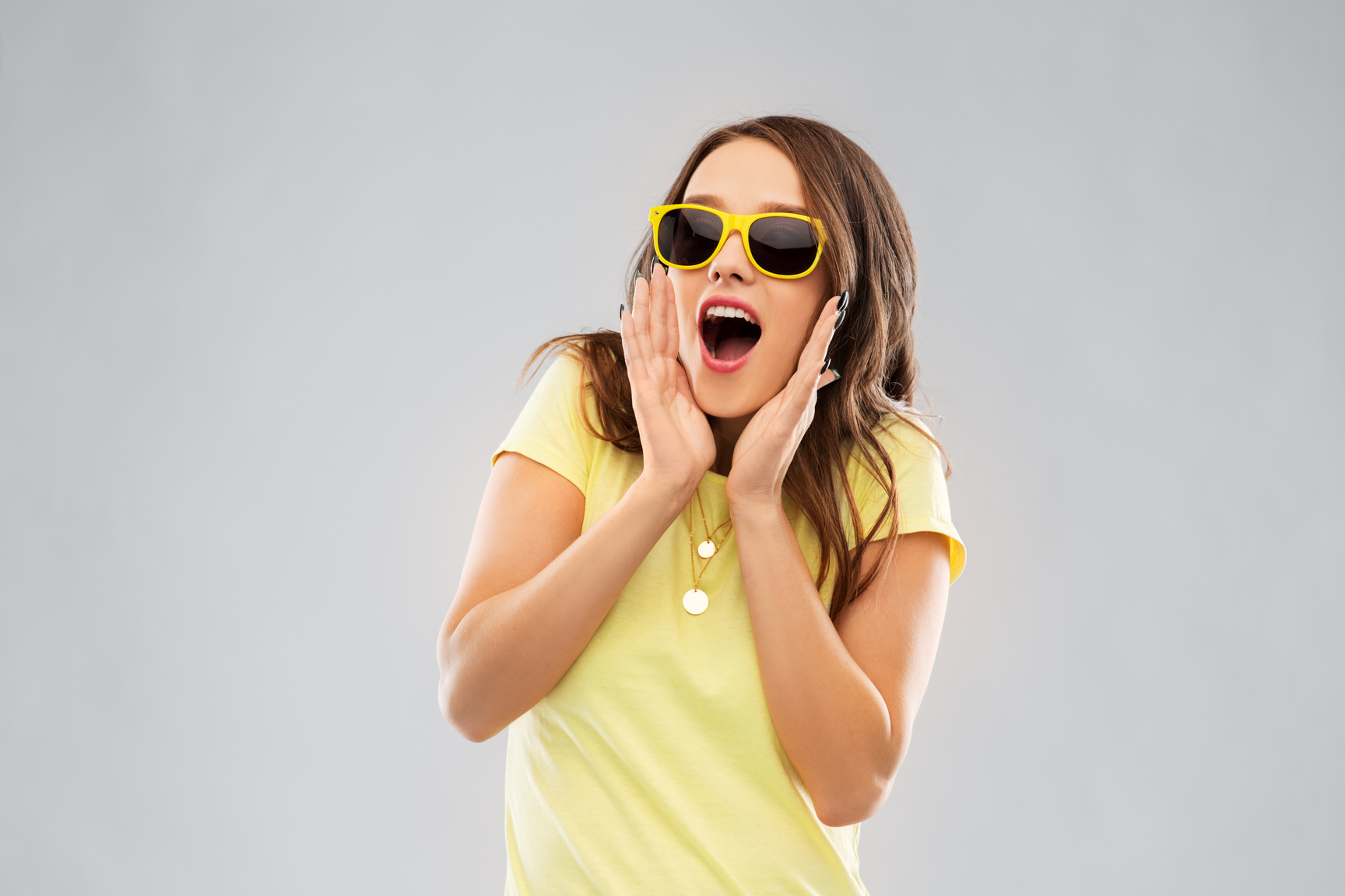 Amazed Teenage Girl in Yellow Sunglasses