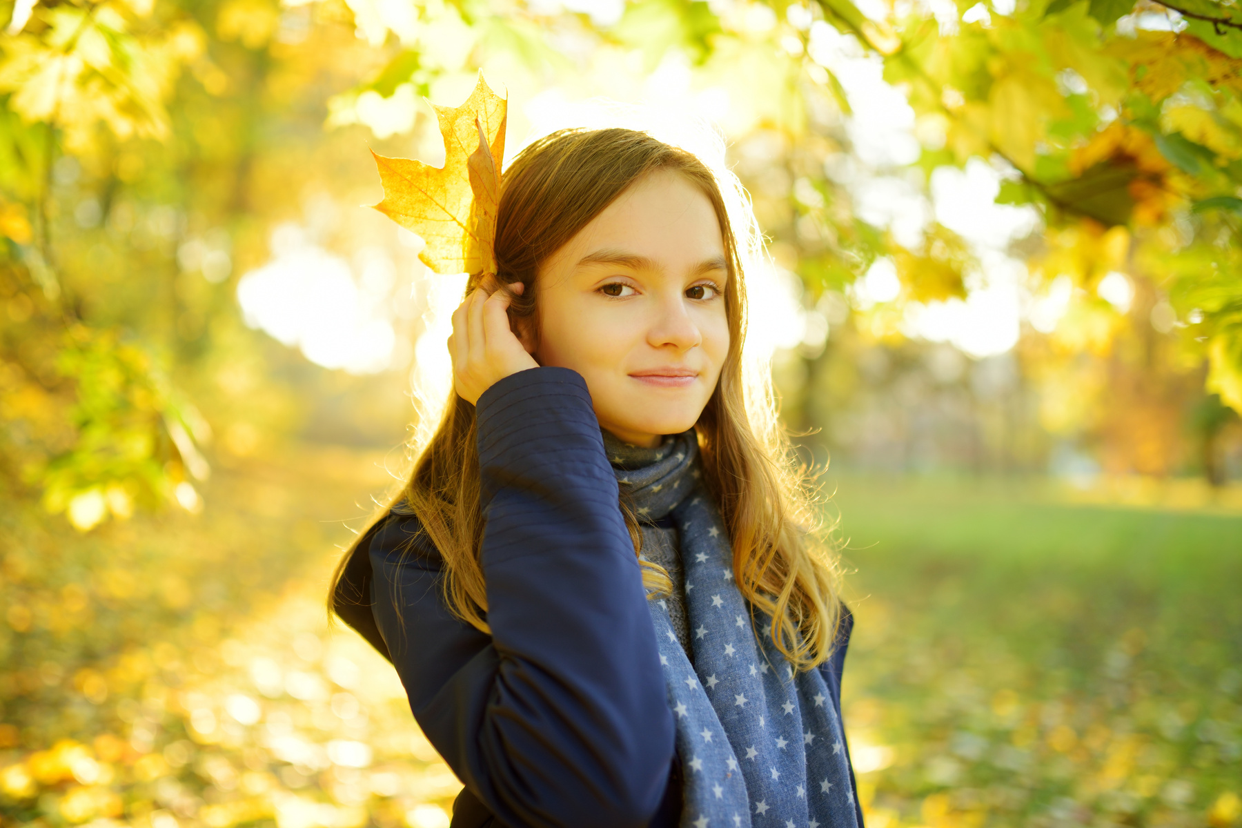 Girl Posing with an Autumn Leaf      