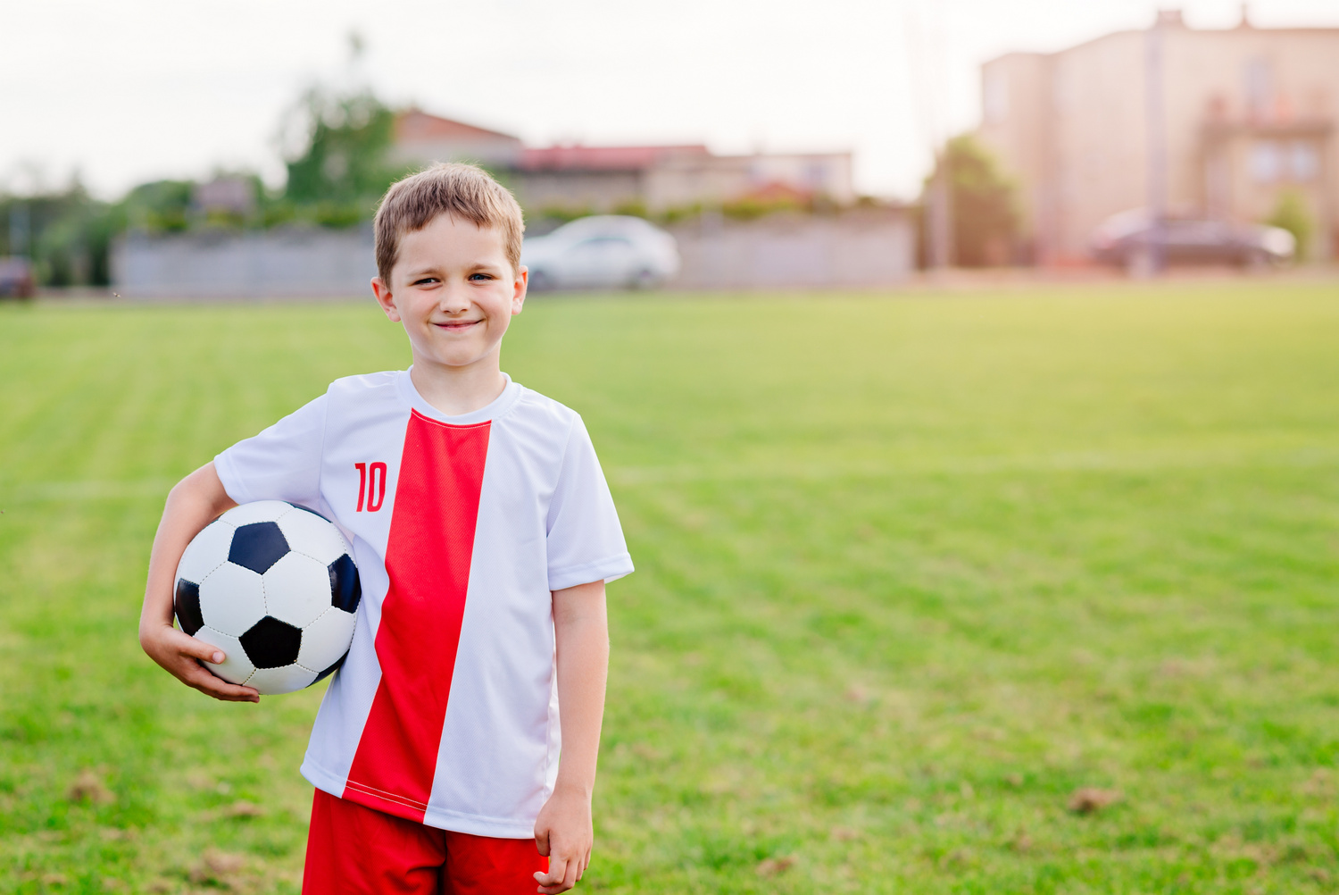 8 years old boy child holding football ball